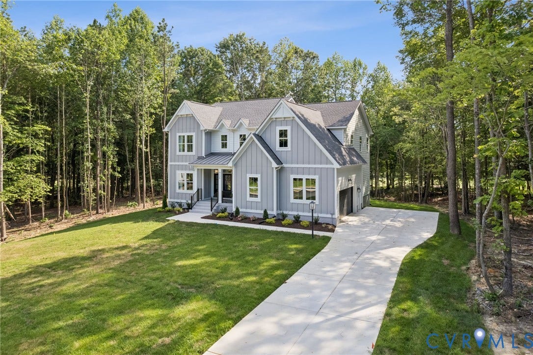 9156 Terroir Lane, Viniterra Villas, New Kent, VA 23124 Newly constructed residence featuring light gray siding with white trim, a dark gray shingle roof, and a prominent front entry with a covered porch