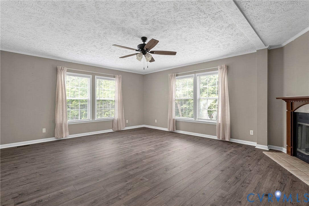 4106 S Spotswood Trail, Trevilians, Louisa, VA 22942 Spacious interior featuring wood-finish flooring, neutral-toned walls, and a ceiling fan