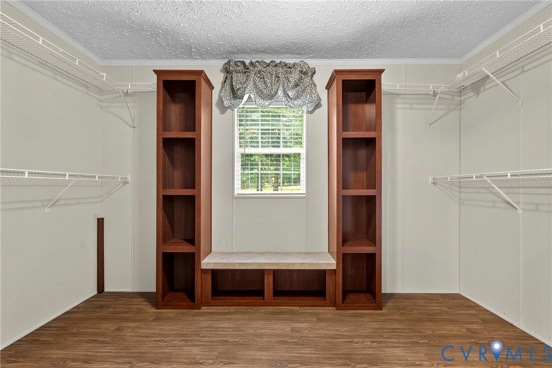 4106 S Spotswood Trail, Trevilians, Louisa, VA 22942 Built-in shelving and bench seating, wood-finish flooring, and wire shelving present versatile storage options
