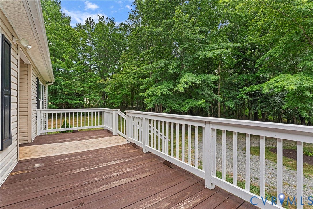 4106 S Spotswood Trail, Trevilians, Louisa, VA 22942 Expansive wooden deck with white railing, featuring a natural wood finish and dark brown decking planks