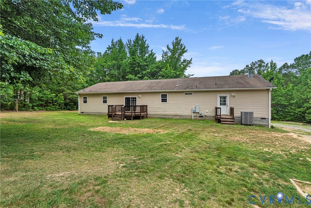 4106 S Spotswood Trail, Trevilians, Louisa, VA 22942 Expansive backyard featuring a wood deck, mature trees, and a gravel drive
