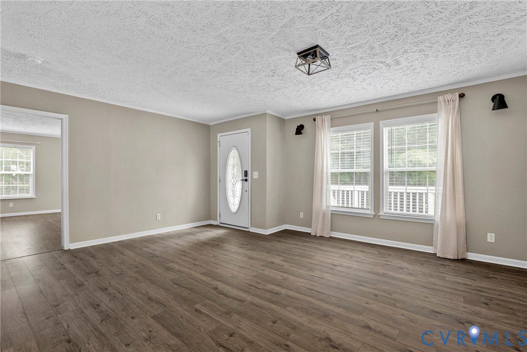 4106 S Spotswood Trail, Trevilians, Louisa, VA 22942 Inviting interior space featuring wood-finish flooring, neutral wall tones, and white trim