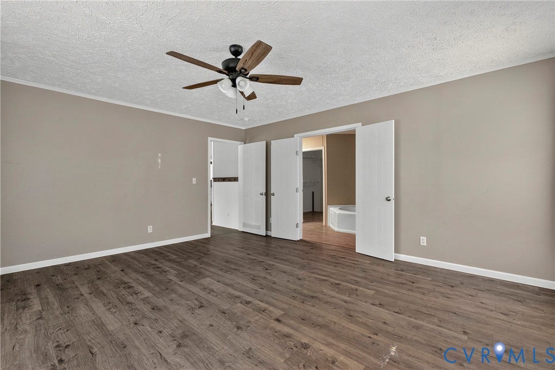 4106 S Spotswood Trail, Trevilians, Louisa, VA 22942 Spacious room featuring wood-finish flooring and a ceiling fan with integrated lighting