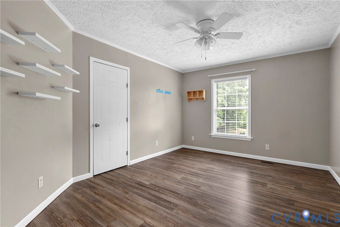 4106 S Spotswood Trail, Trevilians, Louisa, VA 22942 Spacious room featuring wood-finish flooring, neutral-toned walls, and a ceiling fan