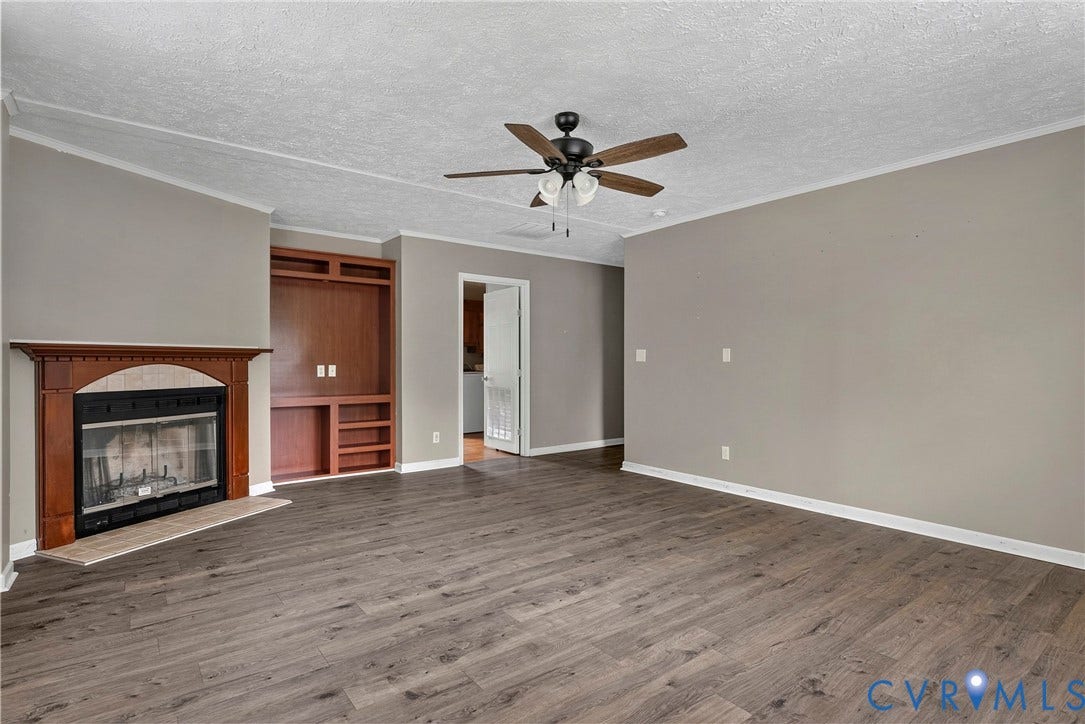 4106 S Spotswood Trail, Trevilians, Louisa, VA 22942 Spacious living area featuring wood-finish flooring, neutral wall tones, and a ceiling fan