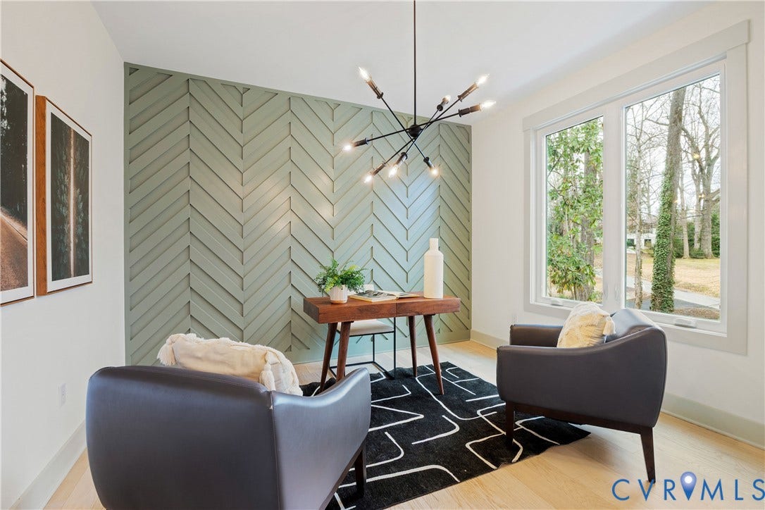 8919 Rustic Road, Richmond, VA 23235 Feature wall with a herringbone wood treatment, large windows with white trim, wood-finish flooring, and a modern sputnik chandelier