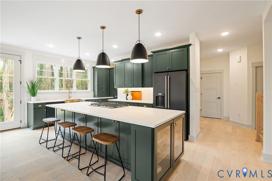 8919 Rustic Road, Richmond, VA 23235 Contemporary kitchen featuring dark green cabinetry, a large central island with seating, a built-in cooktop, and light wood-finish flooring