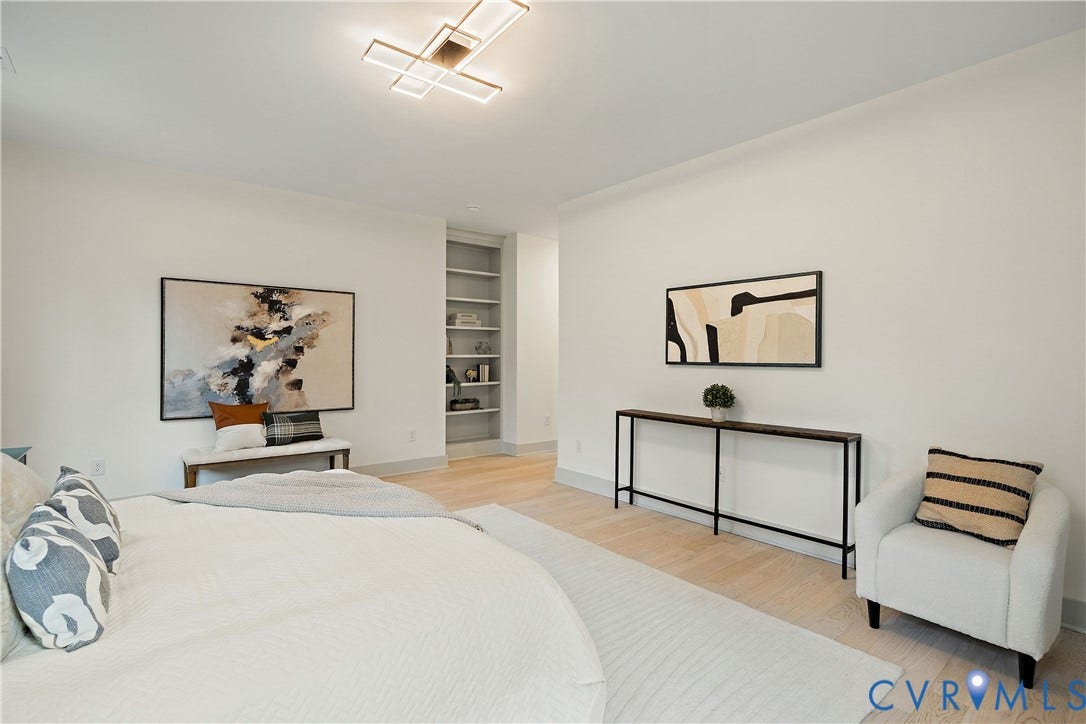 8919 Rustic Road, Richmond, VA 23235 2nd floor primary bedroom featuring light wood-finish flooring, a modern ceiling light fixture, walk-in closet & en-suite bathroom