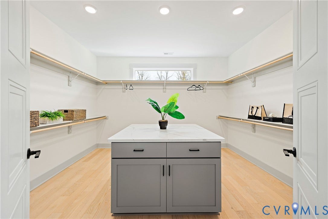 8919 Rustic Road, Richmond, VA 23235 Primary bedroom custom closet featuring light wood-finish flooring, recessed lighting, and an island with quartz