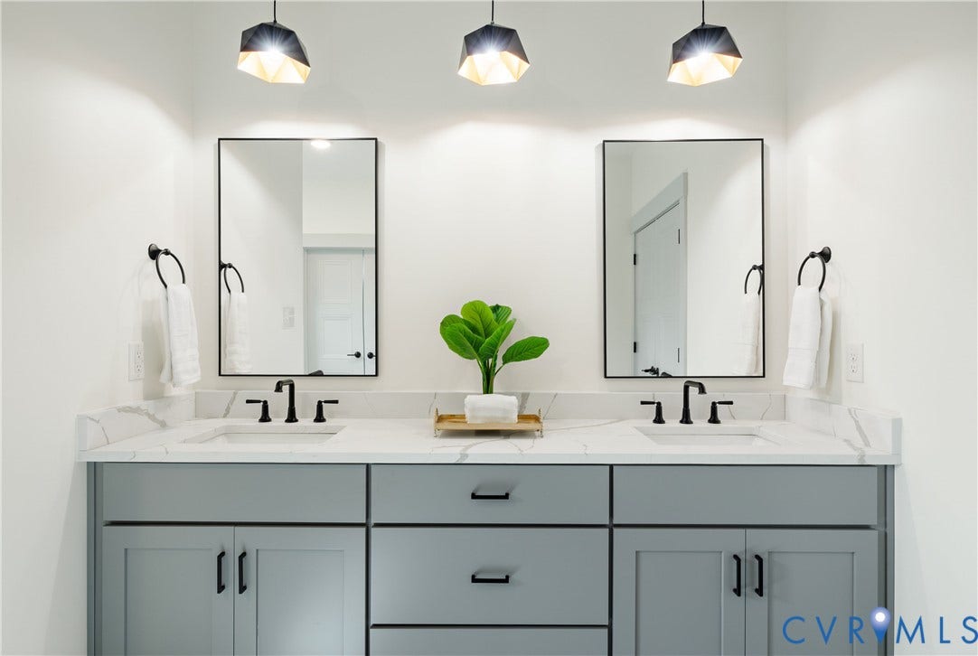 8919 Rustic Road, Richmond, VA 23235 Dual vanity with shaker cabinetry, white countertop, rectangular undermount sinks, and matte black fixtures