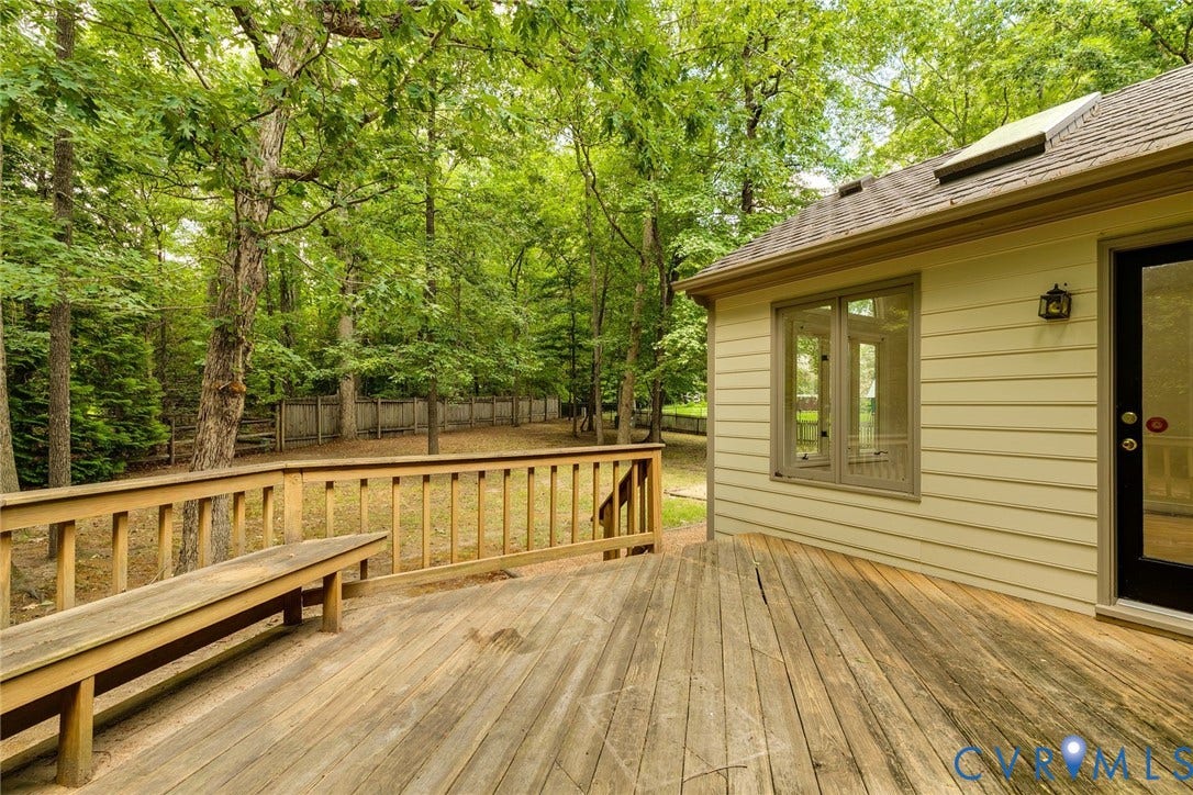 Spacious wood deck with integrated bench seating and wood railing