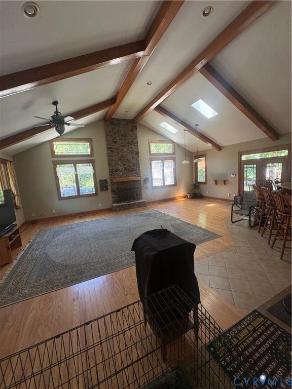 Vaulted ceiling featuring exposed wood beams and recessed lighting