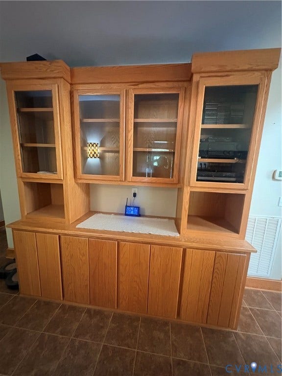 Custom oak built-in cabinetry featuring multiple storage compartments