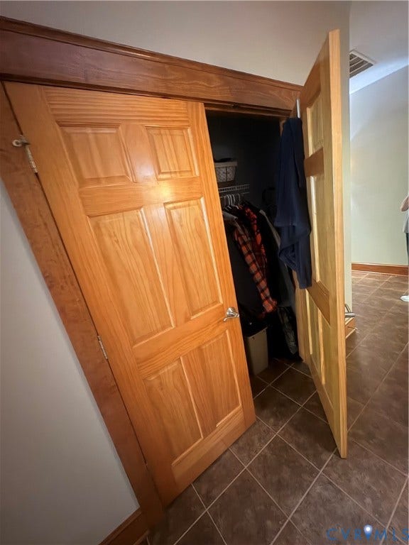 Wood-finish closet doors with polished chrome hardware