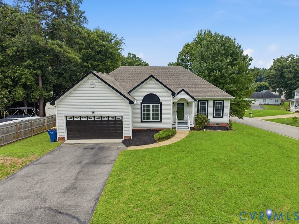 3819 Daniels Street, Chesterfield, VA 23831 White siding residence featuring a dark shingle roof, attached two-car garage with paneling, and a paved driveway