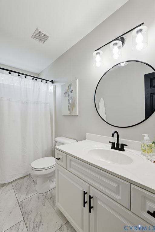 3819 Daniels Street, Chesterfield, VA 23831 Bathroom featuring a white vanity with paneling and matte black hardware, a circular mirror, and a three-light fixture
