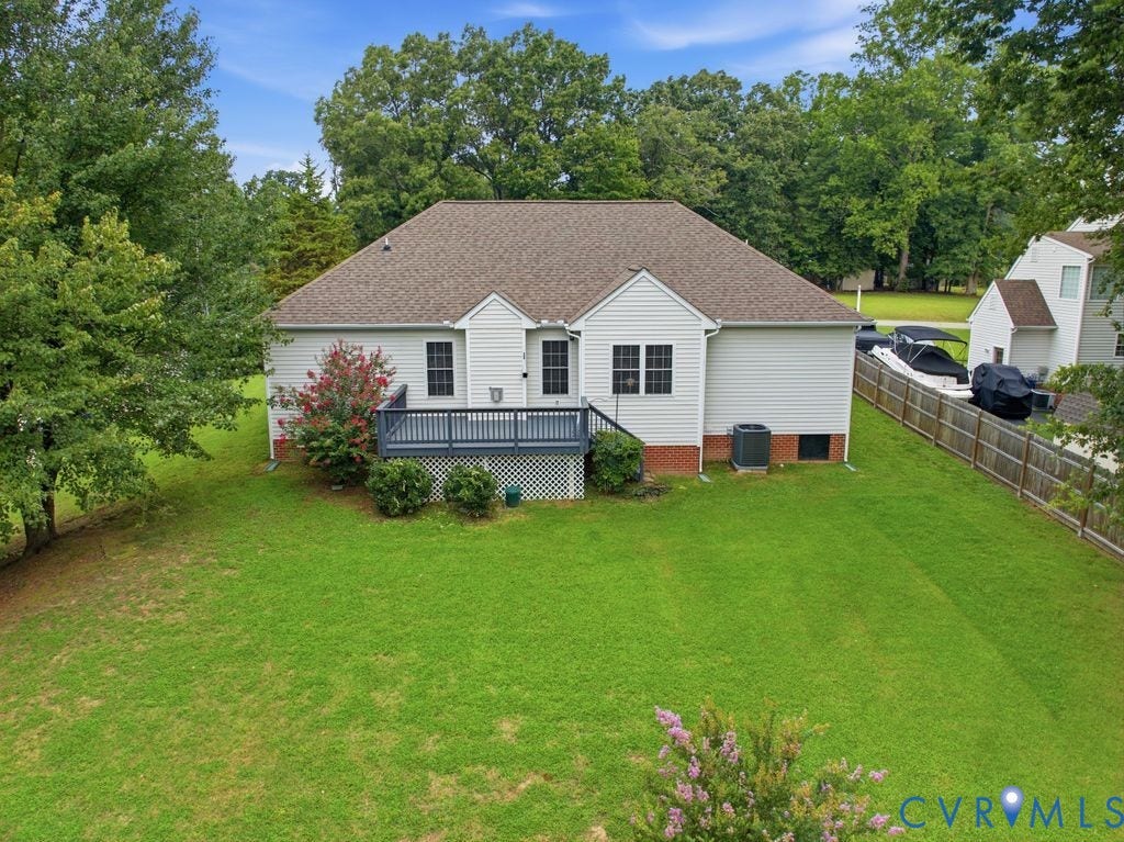 3819 Daniels Street, Chesterfield, VA 23831 Expansive rear yard featuring a wooden deck with dark gray railings, white siding, and a brown shingle roof