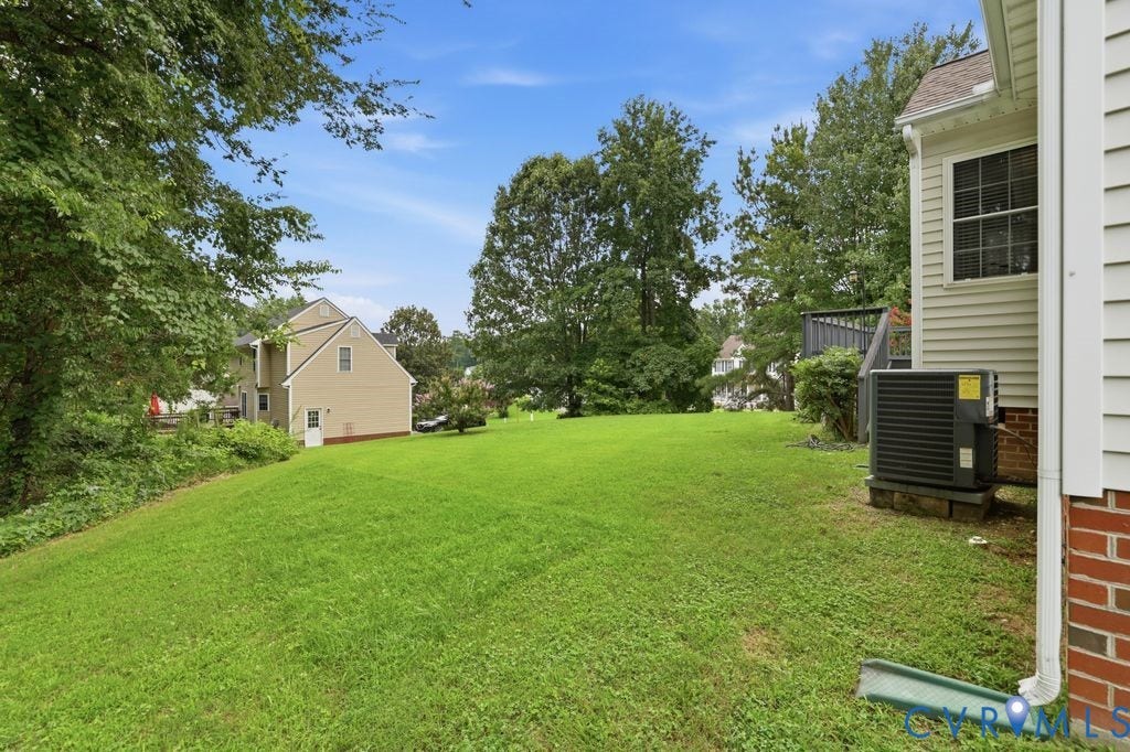 3819 Daniels Street, Chesterfield, VA 23831 Expansive rear yard featuring a large grass area, mature trees, and privacy landscaping