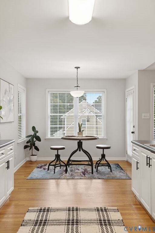 3819 Daniels Street, Chesterfield, VA 23831 Eat-in kitchen area featuring wood-finish flooring, white cabinetry with black hardware, and an overhead pendant light fixture