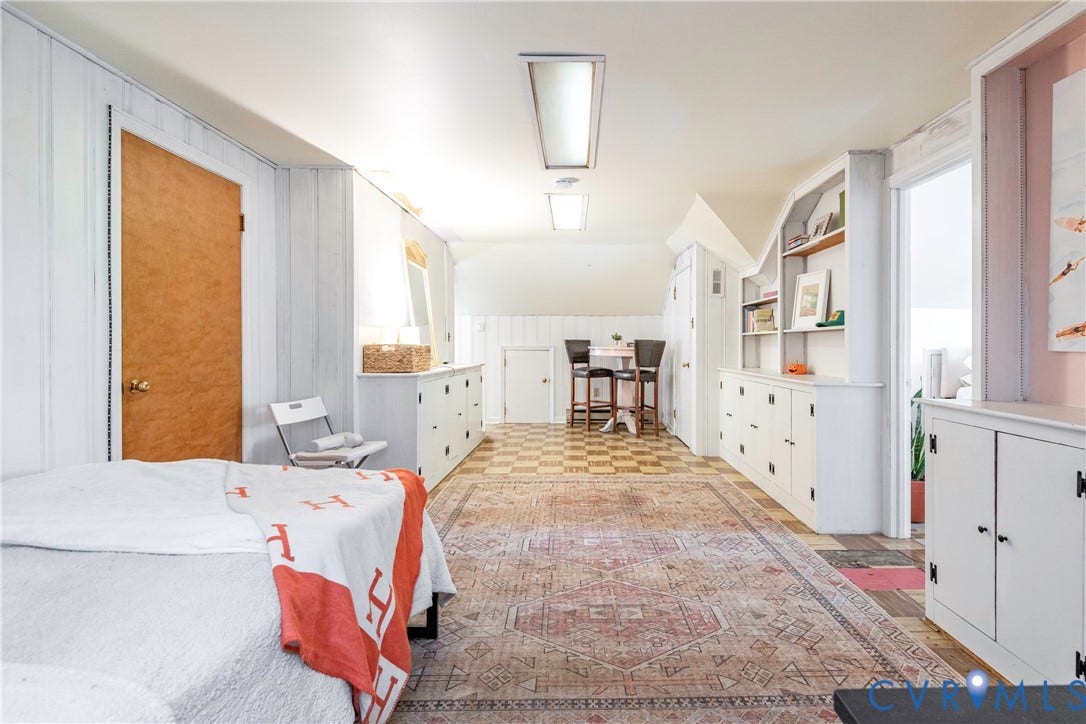 4404 Patterson Avenue, Richmond, VA 23221 Spacious room featuring sloped ceilings, white paneling, and an exposed wood-finish door