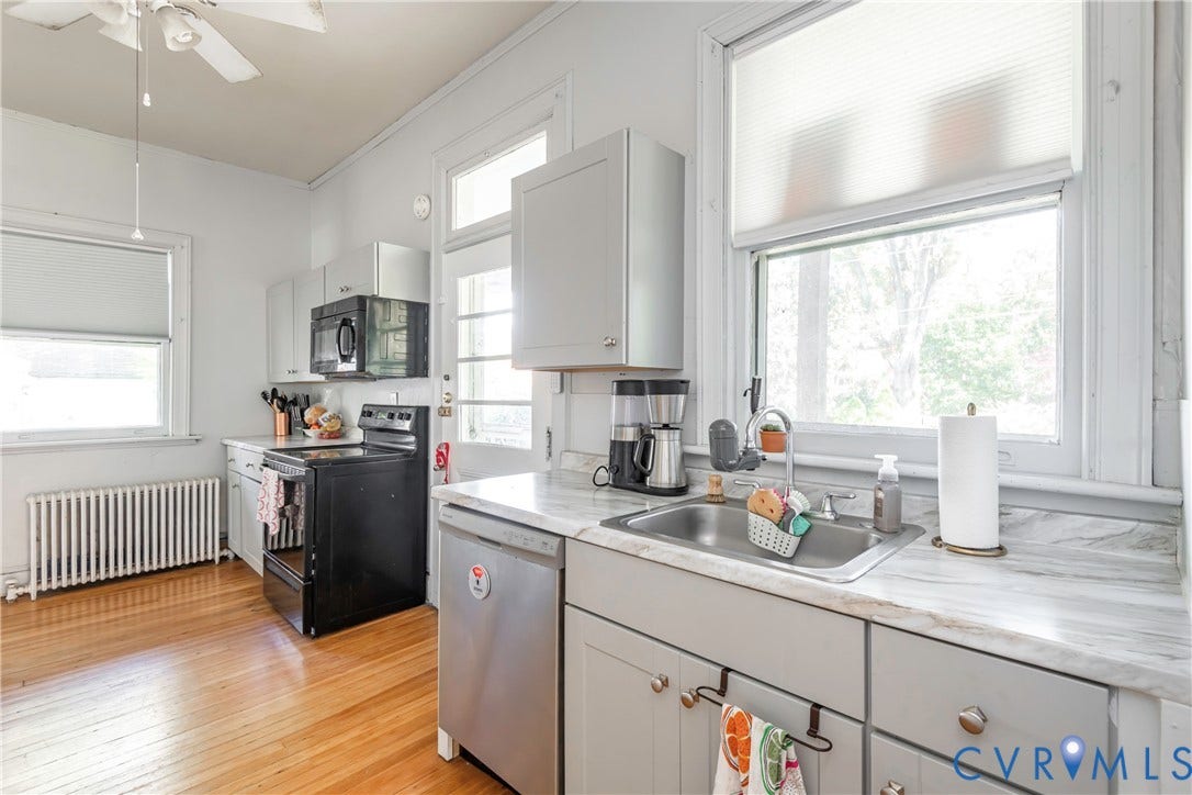 4404 Patterson Avenue, Richmond, VA 23221 Kitchen featuring light wood-finish flooring, light gray cabinetry, and a stainless steel sink