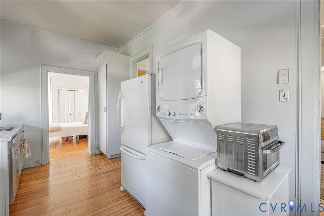 4404 Patterson Avenue, Richmond, VA 23221 Laundry area featuring a stackable washer and dryer, adjacent to a full-size refrigerator
