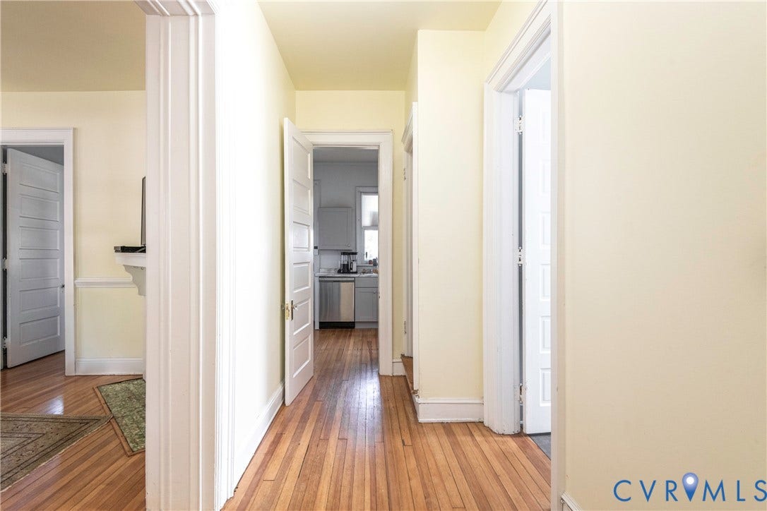4404 Patterson Avenue, Richmond, VA 23221 Corridor featuring wood-finish flooring, white paneled doors, and light-toned walls