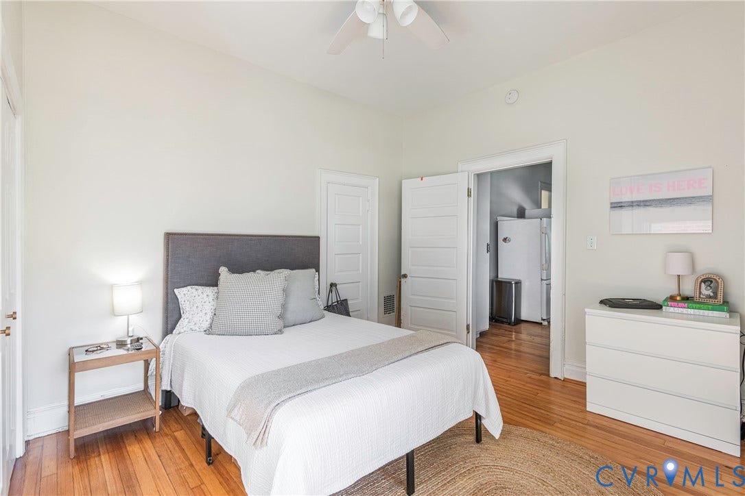 4404 Patterson Avenue, Richmond, VA 23221 Bedroom featuring wood-finish flooring, a ceiling fan, white paneled doors, and light-toned walls