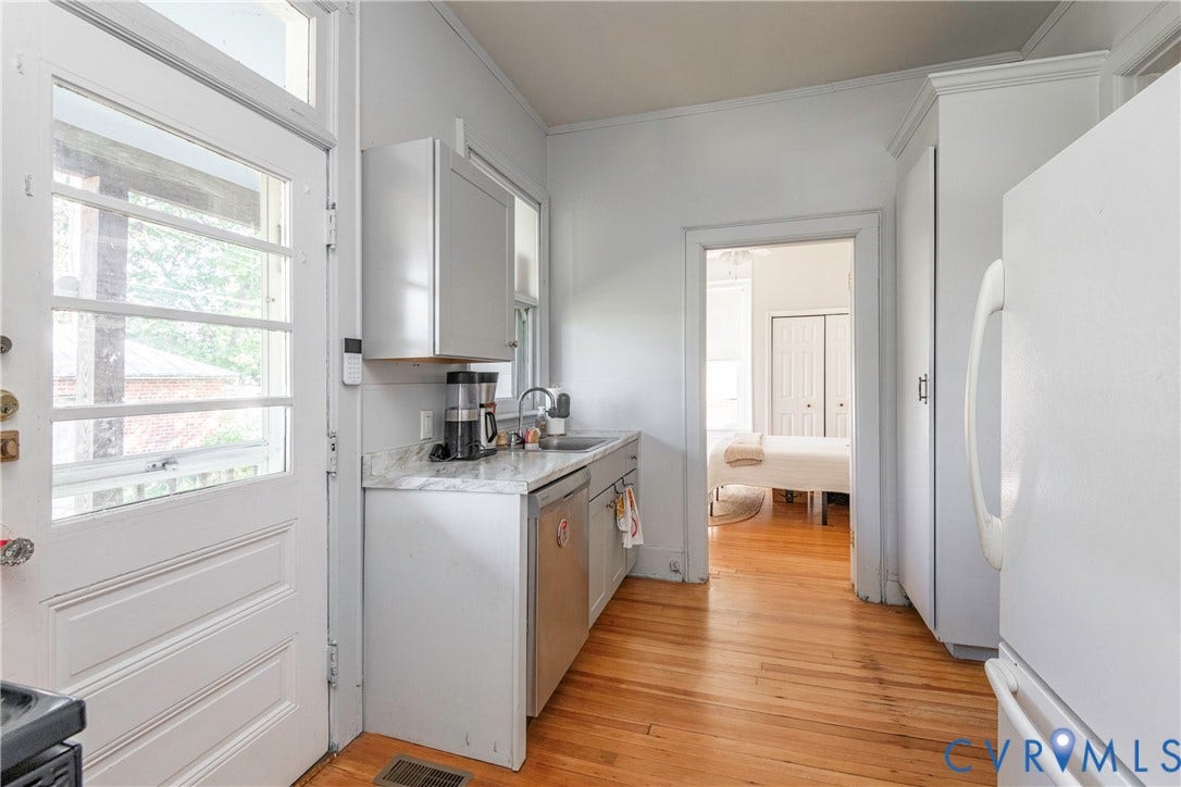 4404 Patterson Avenue, Richmond, VA 23221 Kitchen featuring wood-finish flooring, white cabinetry, and light-toned countertops