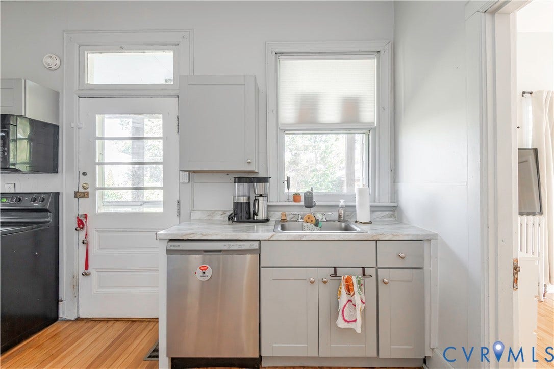 4404 Patterson Avenue, Richmond, VA 23221 Kitchen featuring light gray cabinetry, a stainless steel dishwasher, a single-basin sink, and a countertop with a subtle veining pattern