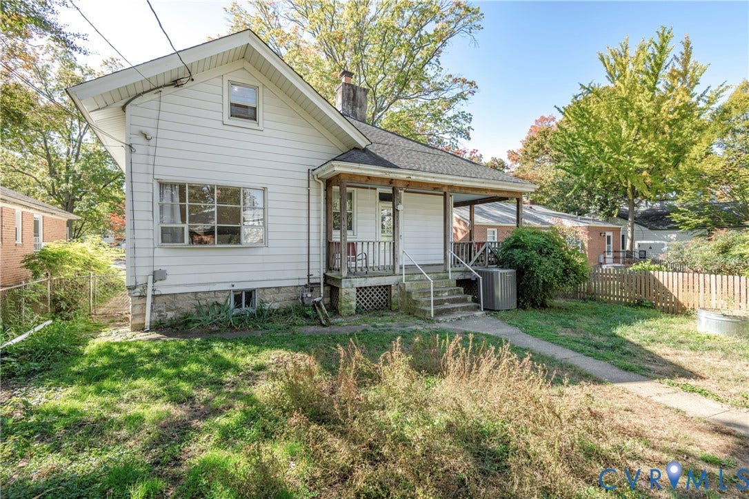 4404 Patterson Avenue, Richmond, VA 23221 White siding exterior with a covered front porch, stone foundation, multi-pane windows, and a fenced backyard