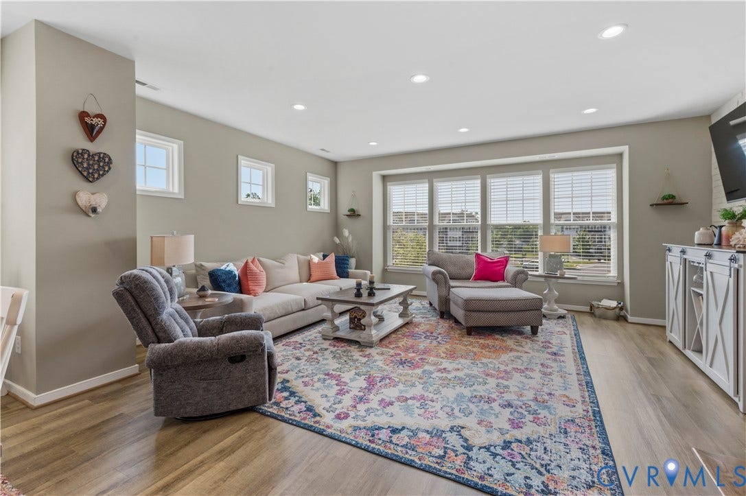 10414 Perennial Drive, Henrico, VA 23233 Spacious living area featuring wood-finish flooring, recessed lighting, and a prominent bay window with multiple panes