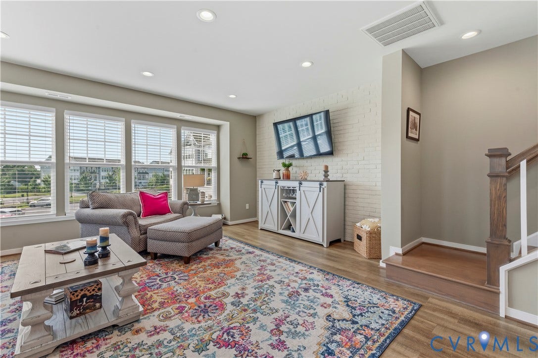 10414 Perennial Drive, Henrico, VA 23233 Living room featuring wood-finish flooring, recessed lighting, and a white painted brick accent wall