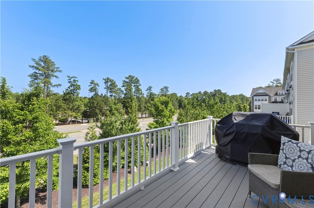 10414 Perennial Drive, Henrico, VA 23233 Expansive outdoor deck featuring a composite surface, white railing, and surrounding mature trees