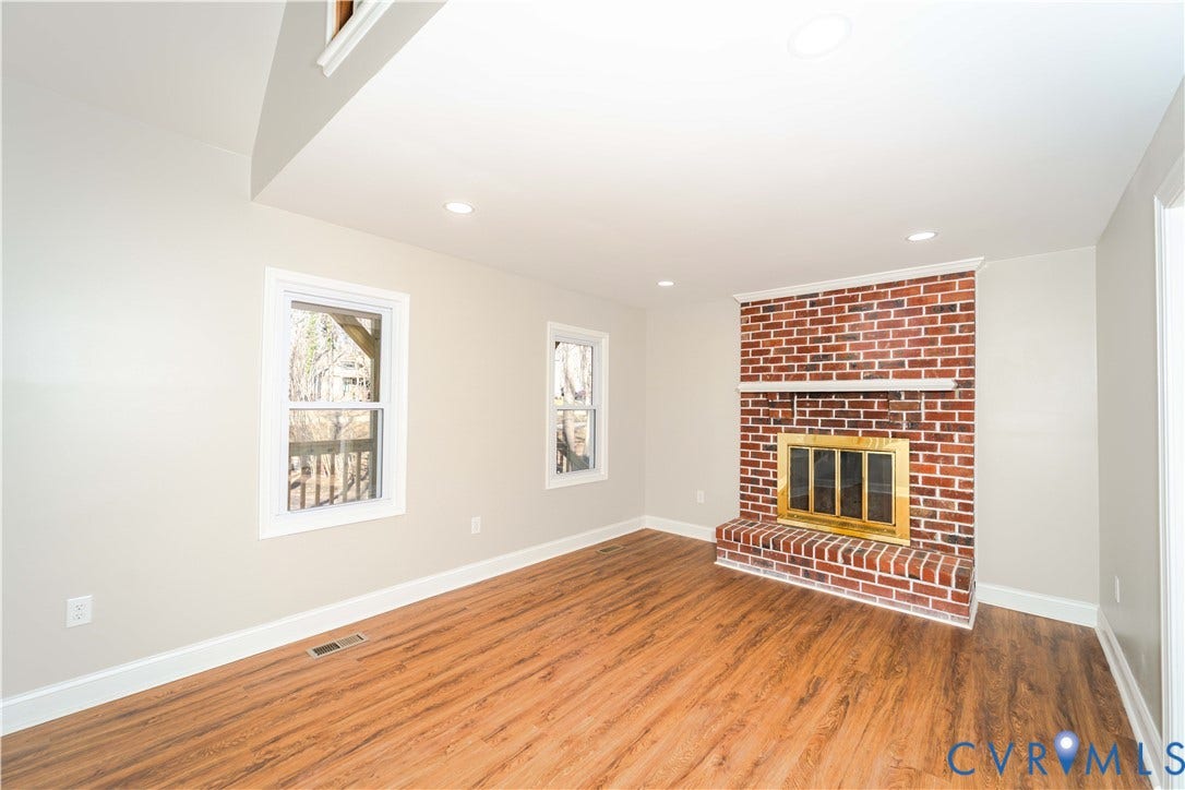 3025 Maplevale Road, Chester, VA 23831 Brick-clad fireplace featuring a brass firebox and white mantel
