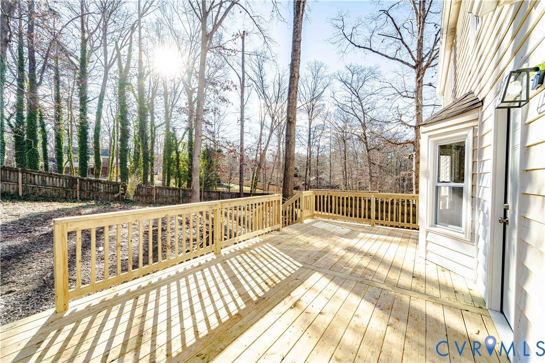 3025 Maplevale Road, Chester, VA 23831 Spacious wooden deck with a natural wood railing, directly accessible from the residence