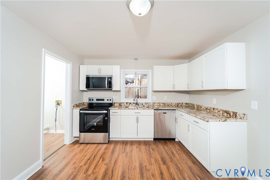 3025 Maplevale Road, Chester, VA 23831 Kitchen featuring wood-finish flooring, white cabinetry, speckled countertops, stainless steel appliances, and a window above the sink