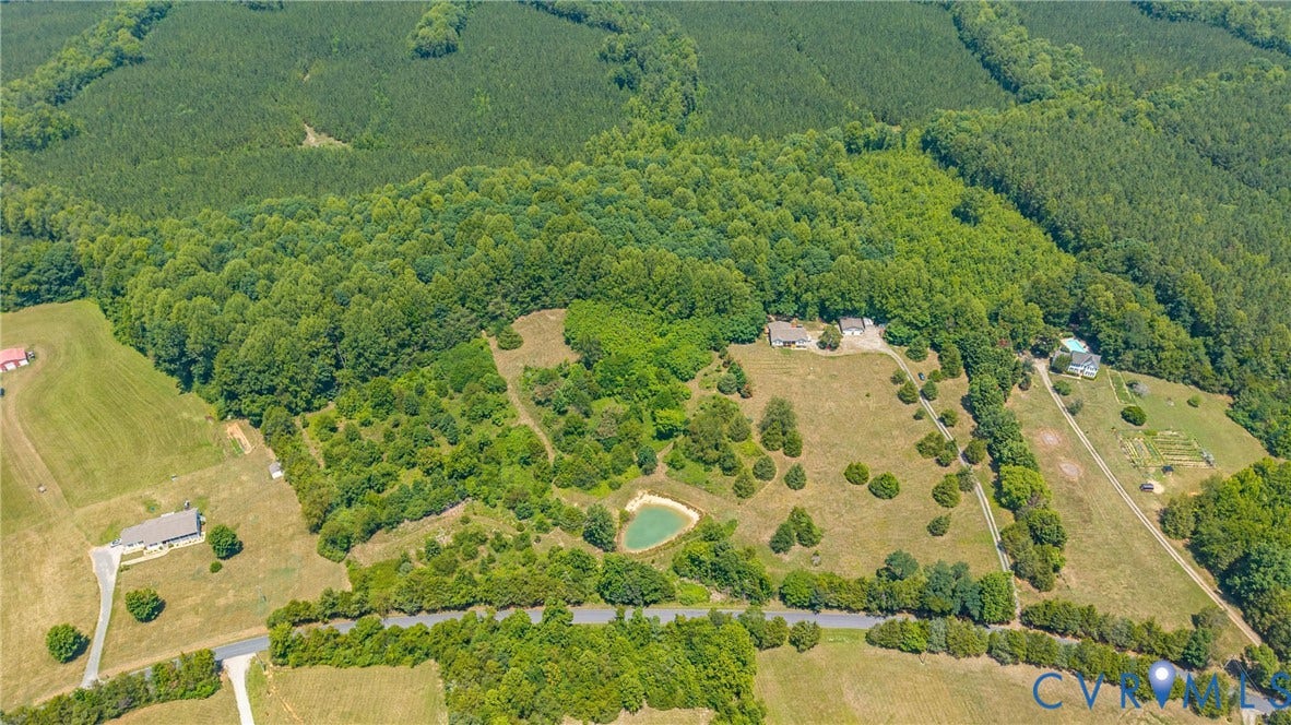 Expansive property featuring a mix of cleared land and dense wooded areas