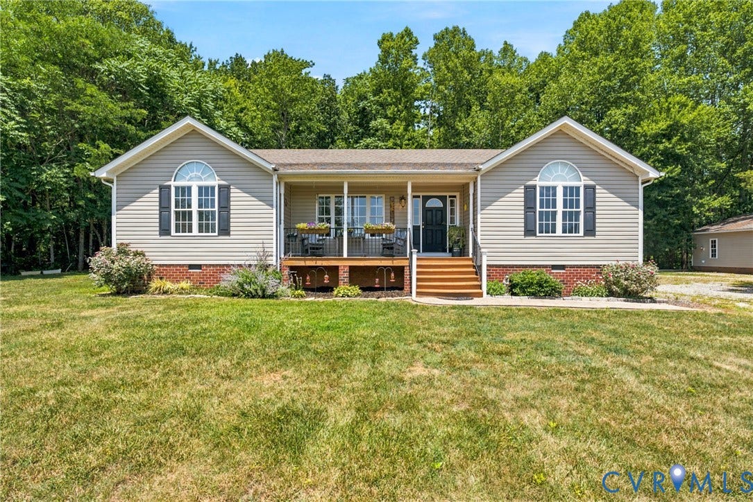 Ranch-style residence featuring light-toned siding and a covered front porch