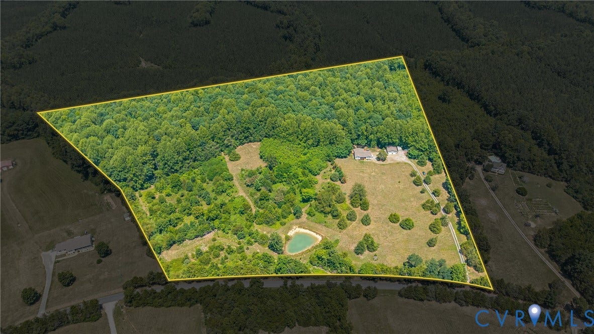 Expansive land parcel featuring a mix of mature woodland and open clearings