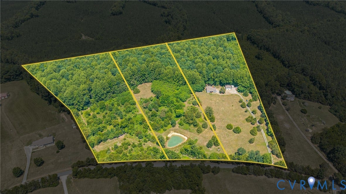 Expansive parcel featuring mature trees, open fields, a private pond, and a residential structure