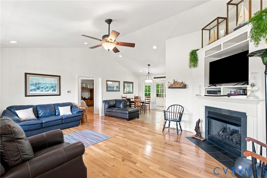 Spacious living area featuring high vaulted ceilings, recessed lighting, and wood-finish flooring