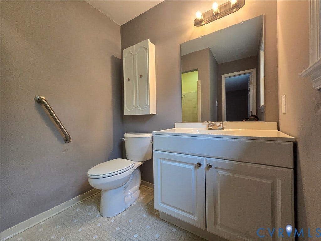 3901 Buckland Place, Chester, VA 23831 Bathroom vanity with a built-in sink, wall-mounted mirror, and overhead light fixture