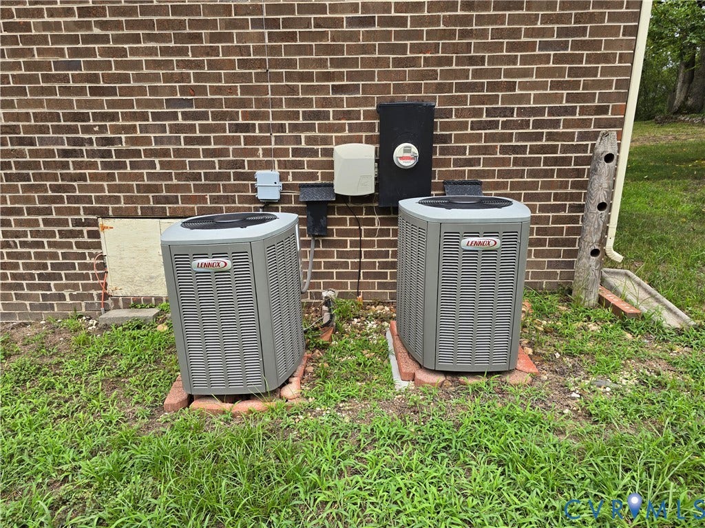 3901 Buckland Place, Chester, VA 23831 Two Lennox brand HVAC condenser units positioned against a brick exterior wall