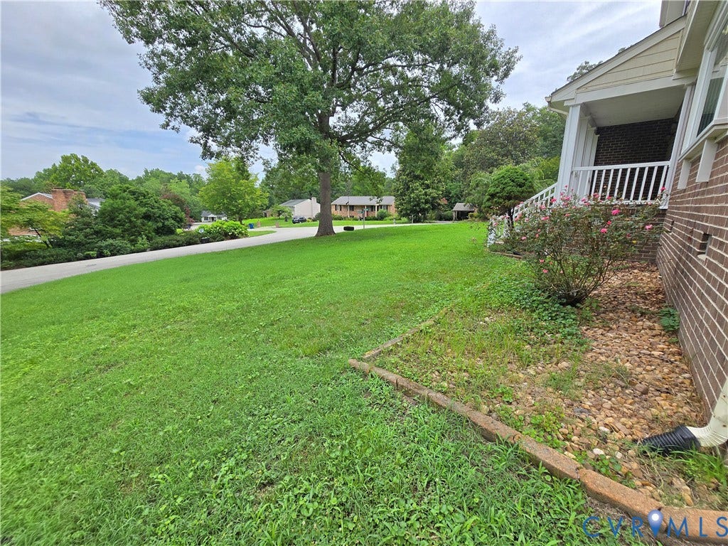 3901 Buckland Place, Chester, VA 23831 Expansive front lawn with mature trees and a brick exterior