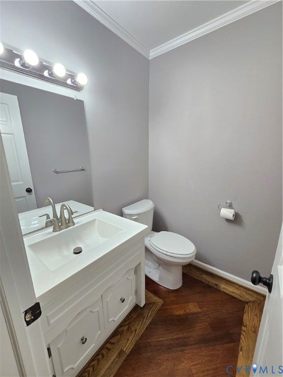 3901 Buckland Place, Chester, VA 23831 Powder room featuring a white vanity with integrated sink, brushed nickel faucet, large wall mirror, and hardwood floors