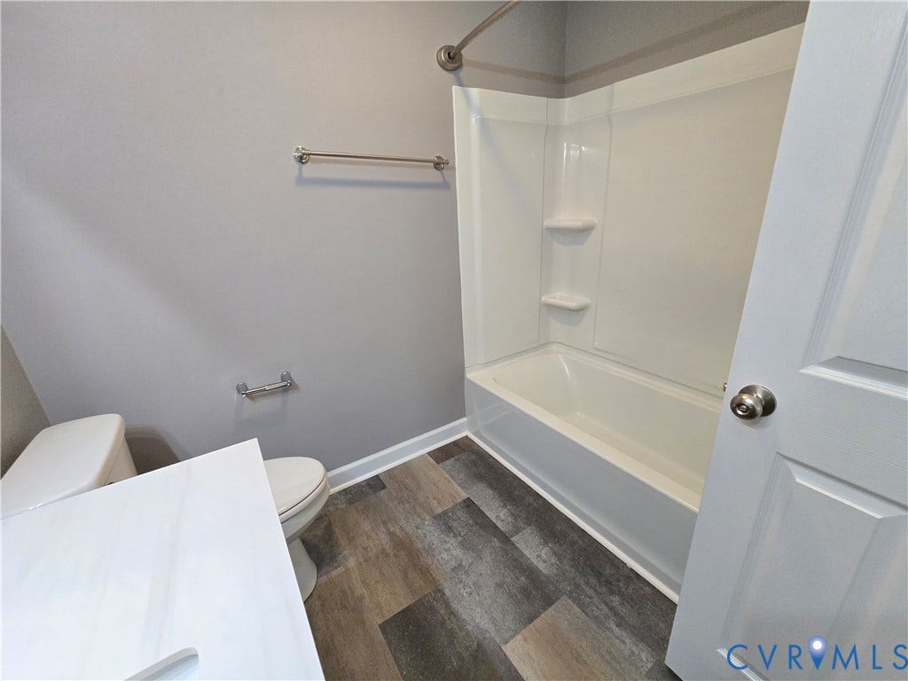 3901 Buckland Place, Chester, VA 23831 Bathroom featuring a white tub/shower combination, wood-finish flooring, white baseboards, and a white vanity countertop