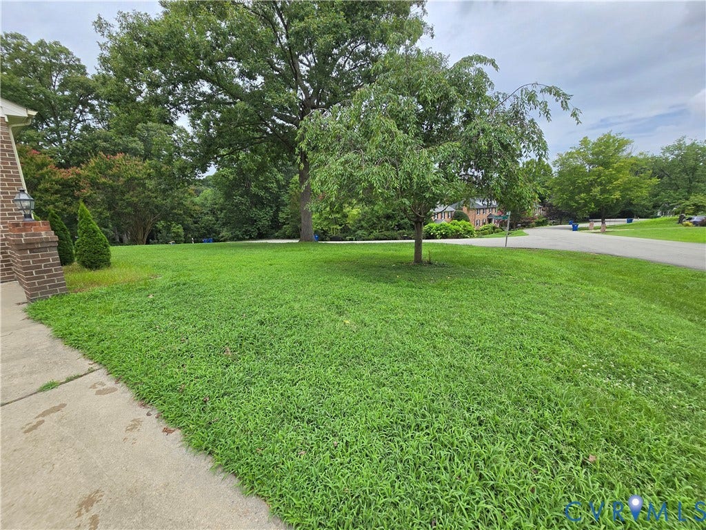 3901 Buckland Place, Chester, VA 23831 Expansive green lawn with mature trees and a concrete pathway