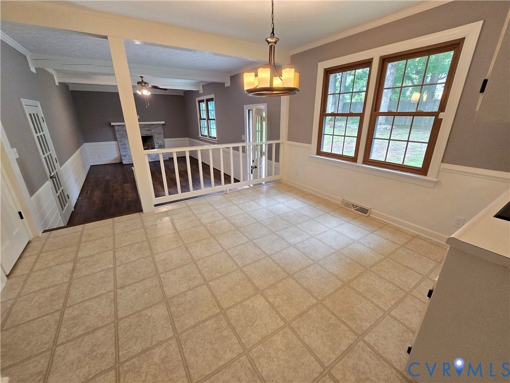 3901 Buckland Place, Chester, VA 23831 Open-concept living area featuring a stone fireplace, wood-finish flooring, and a decorative ceiling fan