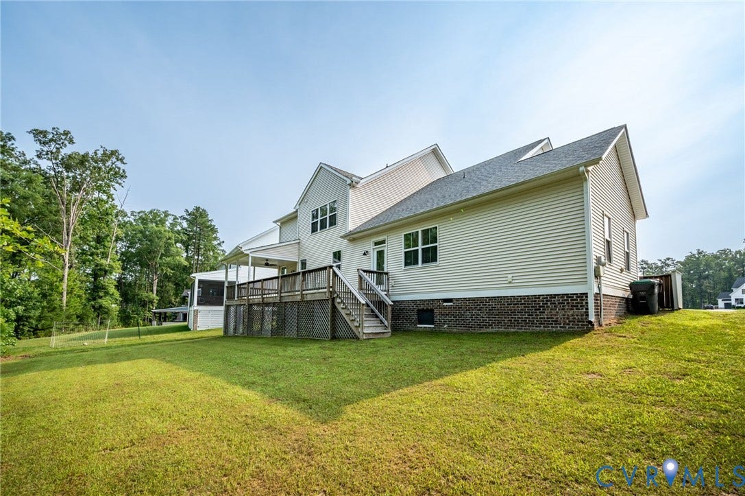 7130 Maple Summit Lane, Moseley, VA 23120 Expansive lawn with a two-story residence featuring light-colored siding and a dark shingle roof